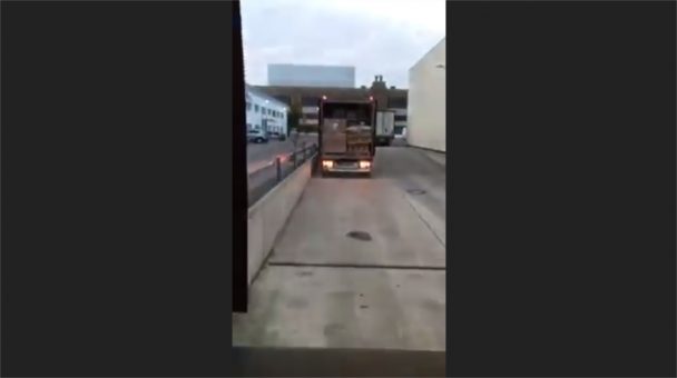 Goods rolled out from the back of a trailer on a slope (Video)