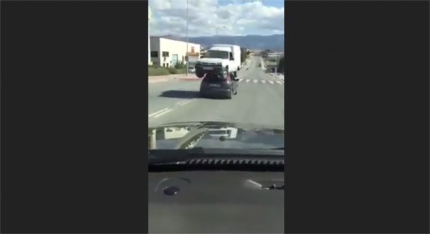 Car transporting another car on its roof (Video)