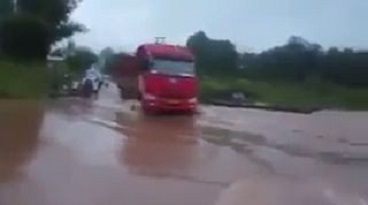 Failed attempt to cross the flooded road (Video)