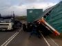 Fellow lorry drivers come to rescue a turned over trailer